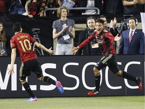 Midfielder Yamil Asad of Atlanta United, right, celebrates with midfielder Miguel Almiron after Asad scores the first goal of the game — and the first goal in Atlanta United history — against the New York Red Bulls at Bobby Dodd Stadium on March 5 in Atlanta. It was the first of 27 goals they've scored this season, tied for tops in MLS.