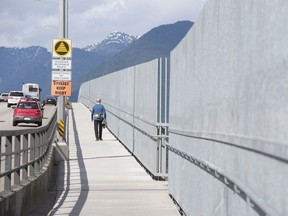 Newly installed anti-suicide fences are pictured along the Iron Workers Memorial bridge linking Burnaby and North Vancouver, B.C. Tuesday, March 31, 2015. The newly installed fences are meant to prevent suicidal people from jumping from the bridge.