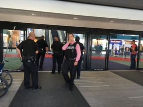 Police officers gather at a terminal at Bishop International Airport, Wednesday morning, June 21, 2017, in Flint, Mich. Officials evacuated the airport Wednesday, where a witness said he saw an officer bleeding from his neck and a knife nearby on the ground.  On Twitter, Michigan State Police say the officer is in critical condition and the FBI was leading the investigation. (Dominic Adams/The Flint Journal-MLive.com via AP) ORG XMIT: MIFLI207

MANDATORY CREDIT
Dominic Adams, AP