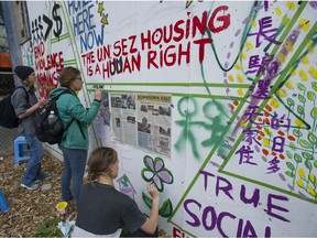 Housing activists and area residents concerned with the housing crisis in Vancouver’s Downtown Eastside take part in a ‘paint-in’ to protest the lack of affordable housing in a spare lot slated for development on W. Hastings Street in May of last year.