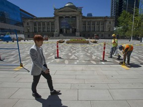 Workers put the final touches on the redesigned North Plaza of the Vancouver Art Gallery before it opened Thursday.