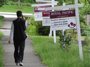 Real estate signs in the 2800-block Kaslo Street in Vancouver on June 13.
