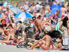 Sun seekers pack Kits Beach in Vancouver.