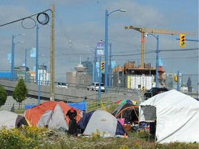 Residents of a homeless camp opposite the B.C. Sugar Refinery in the 100-block Franklin Street in Vancouver on June 28. The camp moved from 950 Main St. after a judge ordered about 50 homeless who have been camping on a city-owned lot in Vancouver designated for social housing to vacate the premises by Wednesday.