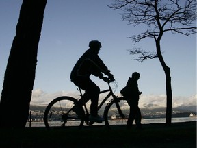 A cyclist enjoys a bike ride on a dry sunny day along Spanish Banks.