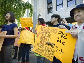 A group of protesters gather outside Vancouver City Hall on May 23 to show their concerns over a development at 105 Keefer St., where they believe there is a dire need for housing Chinatown's many seniors.