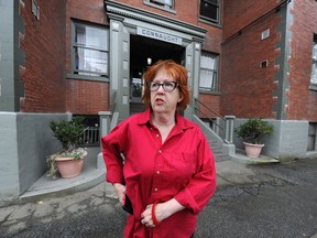 Deb Dawson who had a dispute with her landlord is involved in phone arbitration with the Residential Tenancy Branch, outside her apartment on Guelph Street in Vancouver.