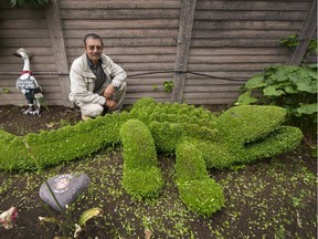 Manuel Fernandes, with his favourite creation, a crocodile, in front of the heart-shaped stone that marks where the ashes of his dog, Dakota, rest after she died last year at age 15.