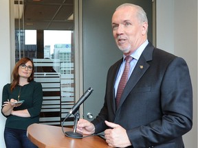 John Horgan addresses the media in response to the federal government's aid package for the softwood lumber industry in June.