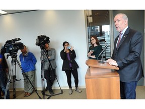 New Democrat Party Leader John Horgan addresses the media Thursday at his party's caucus office in Vancouver.