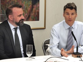 Vancouver Mayor Gregor Robertson, right, with mobility-pricing executive director Daniel Firth, speaks to the media during a Mayors Council and TransLink board meeting to announce appointments to the independent mobility-pricing commission in Vancouver on June 6.