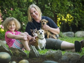 VANCOUVER, BC - MAY 29, 2017 - Kathy Powelson with daughter Maya, 4, and dogs (clockwise from top), Henry, Skippy and Chili, at their home in Maple Ridge, B.C., May 29, 2017.  Kathy Powelson is executive director for Paws for Hope Animal Foundation. Foreign dog rescues are anecdotally on the rise.
