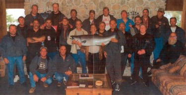 An undated photo of Teamsters Local 31 President Stan Hennessy and members of the Hell's Angels on a fishing trip.  Hennessy is first person on the left in the back row. David Giles is crouching in front, closest to the fish.