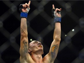 In this Aug. 11, 2012, file photo, Max Holloway celebrates his win over Justin Lawrence in their featherweight bout during UFC 150 in Denver.