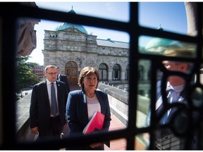 Christy Clark walks from her premier's office at the legislature with press secretary Stephen Smart. Smart remains in the job as part of Clark's new opposition staff team.