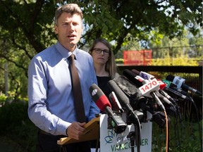 Mayor Gregor Robertson and Kathryn Holm, chief licence inspector for the city, outline the city's next steps for regulating short-term rentals, including Airbnb and Expedia, on July 5 in Vancouver.