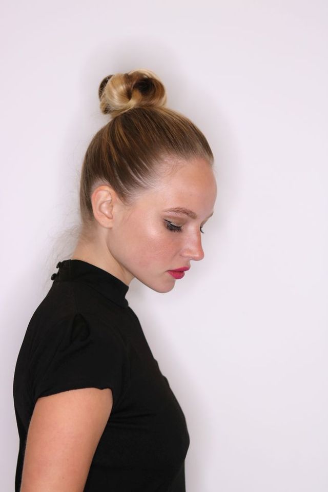 A model sports the "Vacation Twisted Topknot" style by celebrity hairstylist Jen Atkin. 