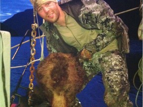 Clayton Stoner, an NHL player for the Minnesota Wild,  holding up a grizzly bear head in this photo taken in May and released to media on September 3.