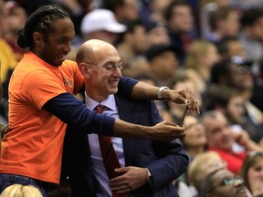 NBA commissioner Adam Silver, right, takes a photo with a fan during the second half of the Washington Wizards and Cleveland Cavaliers game in Washington, DC.