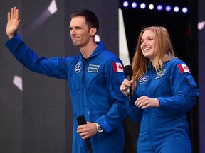 Canada&#039;s newest astronauts Joshua Kutryk and Jennifer Sidey acknowledge the crowd during Canada 150 celebrations on Parliament Hill in Ottawa on Saturday, July 1, 2017. THE CANADIAN PRESS/ Sean Kilpatrick