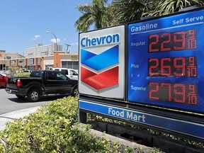 In this Monday, May 15, 2017, photo, motorists pass a Chevron sign listing gas prices, in Miami Springs, Fla. On Friday, July 14, 2017, the Labor Department reports on U.S. consumer prices for June. (AP Photo/Alan Diaz)