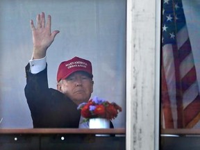 President Donald Trump waves to spectators as he watches the third round of the U.S. Women&#039;s Open Golf tournament from his observation booth, Saturday, July 15, 2017, in Bedminster, N.J. (AP Photo/Seth Wenig)