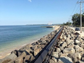 FILE - In this Aug. 26, 2014, file photo, a sea wall separates Asharoken Village, N.Y. from Long Island Sound. A man says his dog jumped into the sound at Port Jefferson, New York, July 16, 2017, to save a baby deer. (AP Photo/Emily Dooley, File)