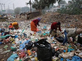 FILE - In this Jan. 21, 2016 file photo, Indian rag pickers look for reusable materials at a garbage dump littered with polythene bags in Lucknow, India. A new massive study finds that production of plastic and the hard-to-breakdown synthetic waste is soaring in huge numbers. The study says since 1950, industry has made more than 9 billion tons of plastics. That‚Äôs enough to cover the entire country of Argentina ankle deep in the stuff. (AP Photo/Rajesh Kumar Singh)