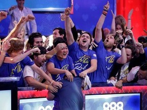 Fans celebrate after Scott Blumstein, bottom center, won the World Series of Poker main event, Sunday, July 23, 2017, in Las Vegas. (AP Photo/John Locher)