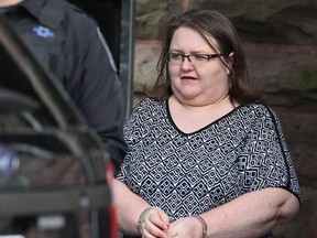 Elizabeth Wettlaufer is escorted by police from the courthouse in Woodstock, Ont, Monday, June 26, 2017. The convicted serial killing nurse who murdered eight seniors in her care faces a professional college disciplinary hearing today. THE CANADIAN PRESS/Dave Chidley