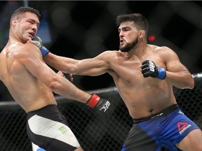 Chris Weidman (L) takes a right hand from Kelvin Gastelum (R) during their UFC Fight Night middleweight bout at the Nassau Veterans Memorial Coliseum on July 22, 2017 in Uniondale, New York.