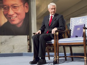 File picture taken on December 10, 2010 shows Nobel Committee Chairman Thorbjorn Jagland sitting during the Peace Prize Ceremony in Oslo infront of a photo of Nobel peace laureate Liu Xiaobo who died July 13, 2017.