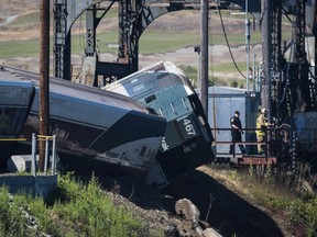 Emergency crews respond to the scene of a train derailment near Chambers Bay on Sunday, July 2, 2017, in Tacoma, Wash. There appear to be only minor injuries from the waterfront derailment of the Amtrak Cascades train near the town of Steilacoom, the Pierce County Sheriff's Office said on Twitter. The train runs between Vancouver, Canada, and Eugene-Springfield, Oregon.