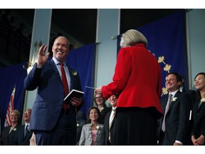 Premier John Horgan takes the oath of office on July 18. His government spent almost $300,000 on advisers to help during the transition to power.