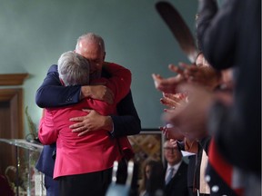 Premier John Horgan hugs Deputy Premier Carole James after being sworn-in during a ceremony with his provincial cabinet at Government House in Victoria, B.C., on Tuesday, July 18, 2017.