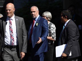Premier John Horgan leaves Government House after being sworn in as premier in Victoria, B.C., on Tuesday, July 18, 2017.