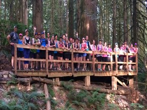 Members of Garrison Running Company's fun run club take a break on a bridge in Community Forest for a group photo. On Saturday many of them will be taking part in a fun public run/walk to raise money for B.C.'s wildfire victims.
