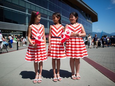 From left to right, ten-year-old triplets, Elizabeth Ferguson, Danielle Ferguson and Chloe Ferguson, who were born in the United Arab Emirates, pose for a photograph after receiving their Canadian citizenship during a special Canada Day ceremony in Vancouver, B.C., on Saturday July 1, 2017. THE CANADIAN PRESS/Darryl Dyck