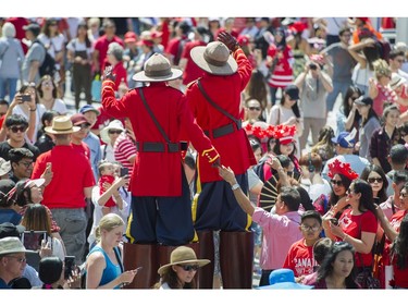 Stilt walkers dressed as Mounties walk among the crowd at the Canada Day celebrations at Canada Place, Vancouver, July 01 2017.
