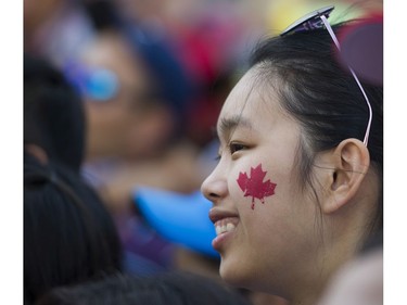 A woman sports a maple leaf on her cheek at the Canada Day celebrations at Canada Place, Vancouver, July 01 2017.