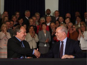B.C. NDP leader John Horgan and B.C. Green party leader Andrew Weaver shake hands after signing an agreement on creating a stable minority government during a press conference in the Hall of Honour at Legislature in Victoria on May 30, 2017.
