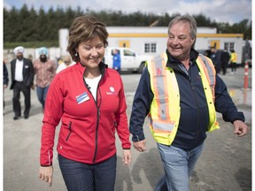 Former Premier Christy Clark, with Hydro board chair Brad Bennett, chat while she made a campaign stop in Surrey in May. Bennett was replaced on Thursday in a Hydro shakeup by new B.C. Premier John Horgan.