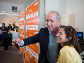 B.C. Premier John Horgan and new-to-the-job minister of municipal affairs and housing Selina Robinson posed for selfies during the provincial election campaign in Coquitlam.