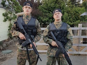 Karl Lofstrom,18, left, and his brother Tylor, 23, dressed in camouflage gear and carrying airsoft guns that resemble high-powered rifles.