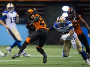 B.C. Lions' Ronnie Yell (25) is stopped by Winnipeg Blue Bombers' Andrew Harris after intercepting a pass from quarterback Matt Nichols, back left, during the second half of a CFL football game in Vancouver, B.C., on Friday July 21, 2017. 
DARRYL DYCK,