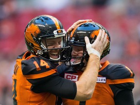 B.C. Lions' quarterback Travis Lulay, left, and Ty Long celebrate after Long kicked a field goal against the Edmonton Eskimos during the first half of a CFL football game in Vancouver, B.C., on Saturday, June 24, 2017.