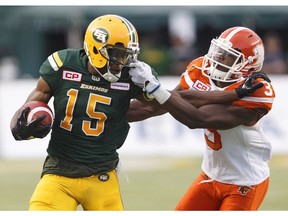 Defnsive back Buddy Jackson of the B.C. Lions grabs the face mask of Eskimos' receiver Vidal Hazelton during Friday's CFL game at Commonwealth Stadium in Edmonton.