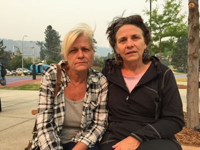 Benita Gies (left) and Cheryl Klaver sit outside the Kamloops Emergency Social Services reception centre on Monday. They were both evacuated from 100 Mile House on Sunday night after previously being evacuated from their homes in 103 Mile and Lac La Hache, respectively.