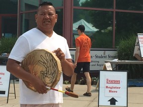 David Archie, with the Secwepemc Health Caucus, invites evacuees to a First Nations healing ceremony that was held on a basketball court outside the Kamloops Emergency Social Services evacuee reception centre on Tuesday.