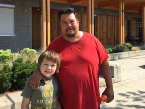 Dennis Binette and his son, Dennis Jr. (also known as DJ), outside the Emergency Social Services evacuee reception centre at Chilliwack Secondary School.